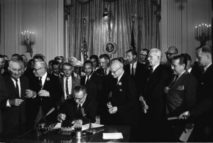 Lyndon Johnson signing the Civil Rights Act of 1964.