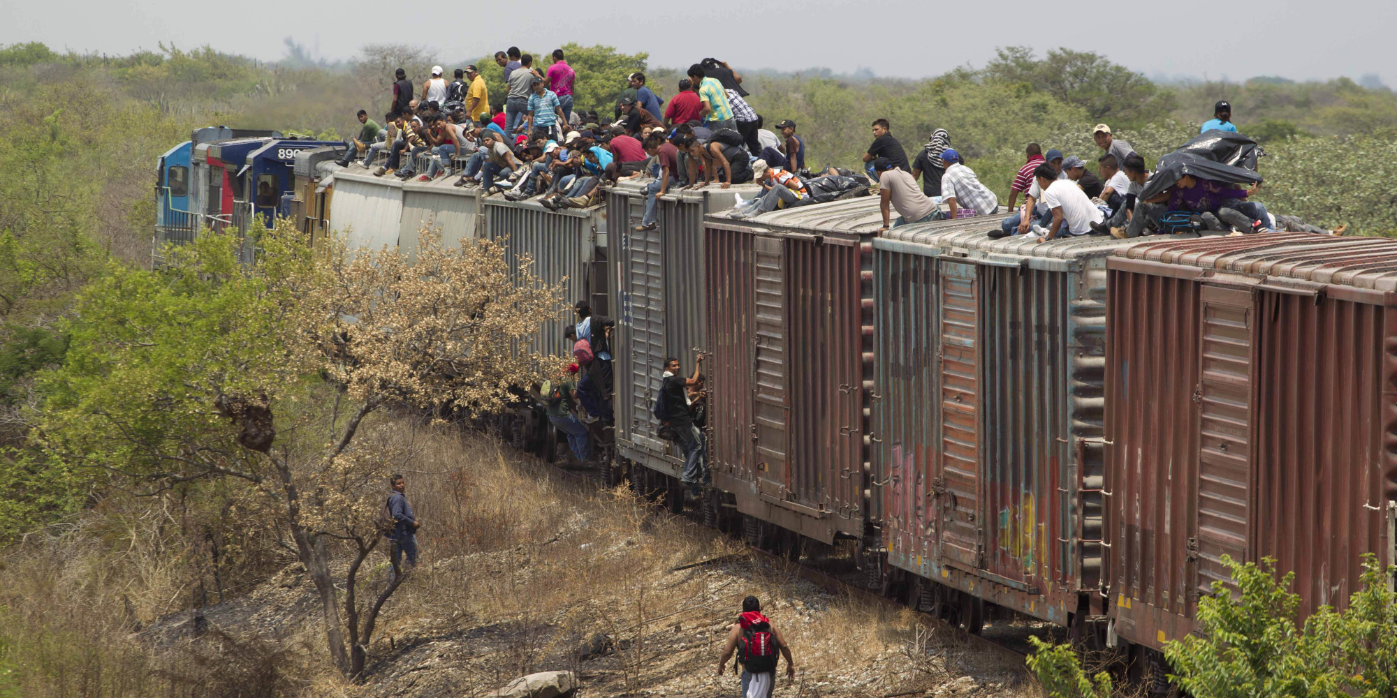 FILE - In this April 29, 2013 file photo, migrants ride on top of a northern bound train toward the US-Mexico border in Union Hidalgo in Oaxaca, Mexico. Al Jazeera America will air a series titled Borderland which takes average Americans with strong opinions about illegal immigration through the same deadly journey that is taken by people trying to reach the U.S. The series premieres on April 13, 2014. (AP Photo/Eduardo Verdugo, File)